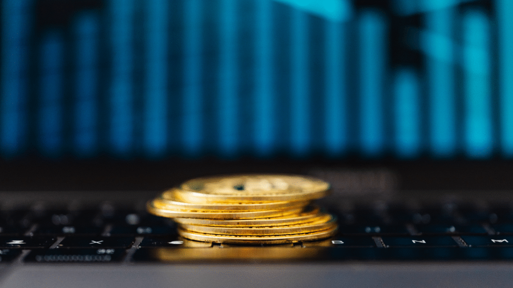 Home laptop with investing coins on keyboard